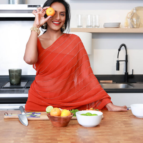 woman holding an orange for healthy eating lifestyle branding photoshoot