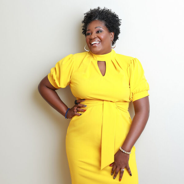 woman in yellow dress posing for a photoshoot
