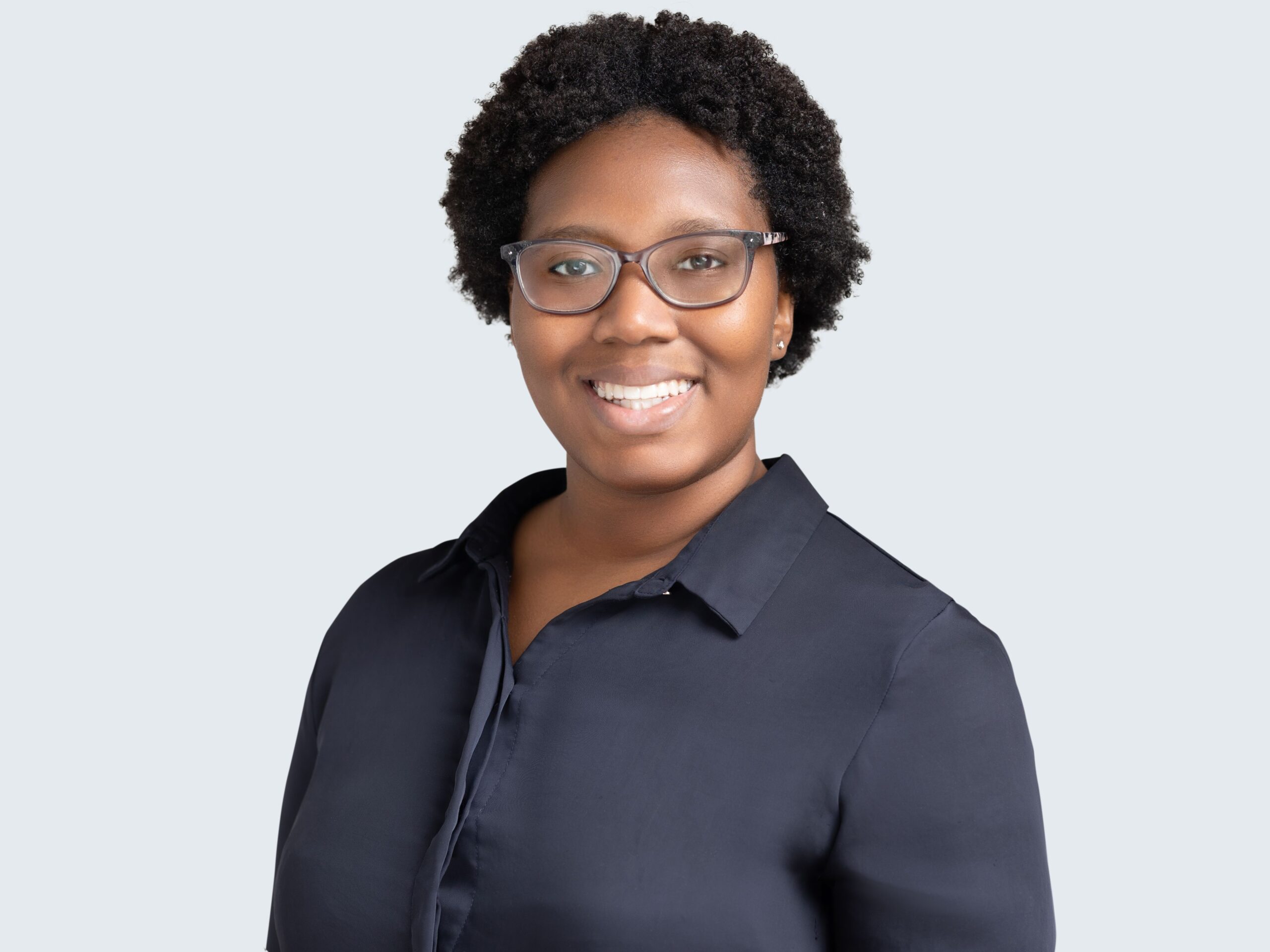 woman in glasses smiling for luxury headshots