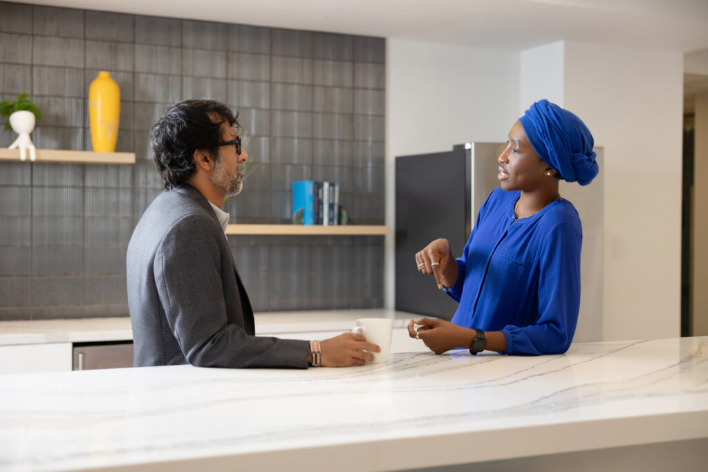 representing company culture - two coworkers chatting in the breakroom